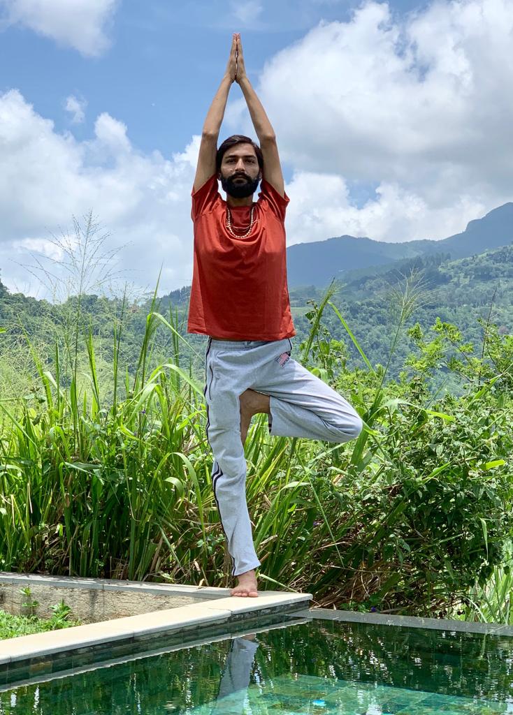 Hatha Yoga teacher Ayush performing Vrikshasana (Tree Pose) is a balancing asana. 