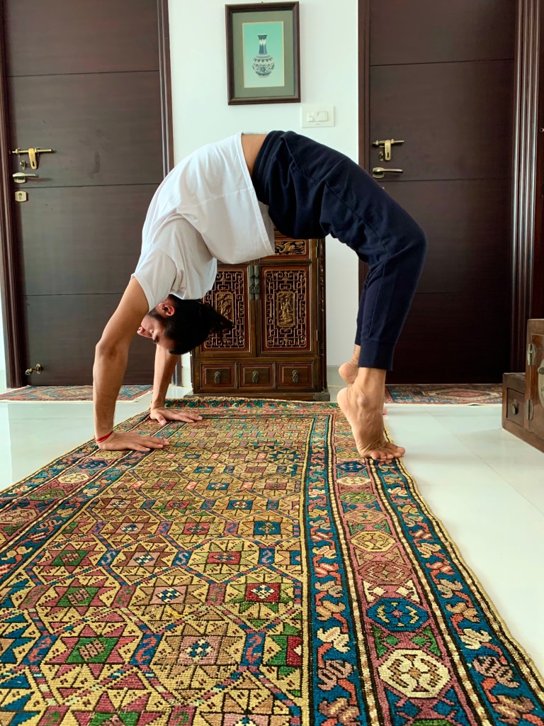 Hatha Yoga Teacher Ayush performing Wheel Pose (Back bending Asana). 