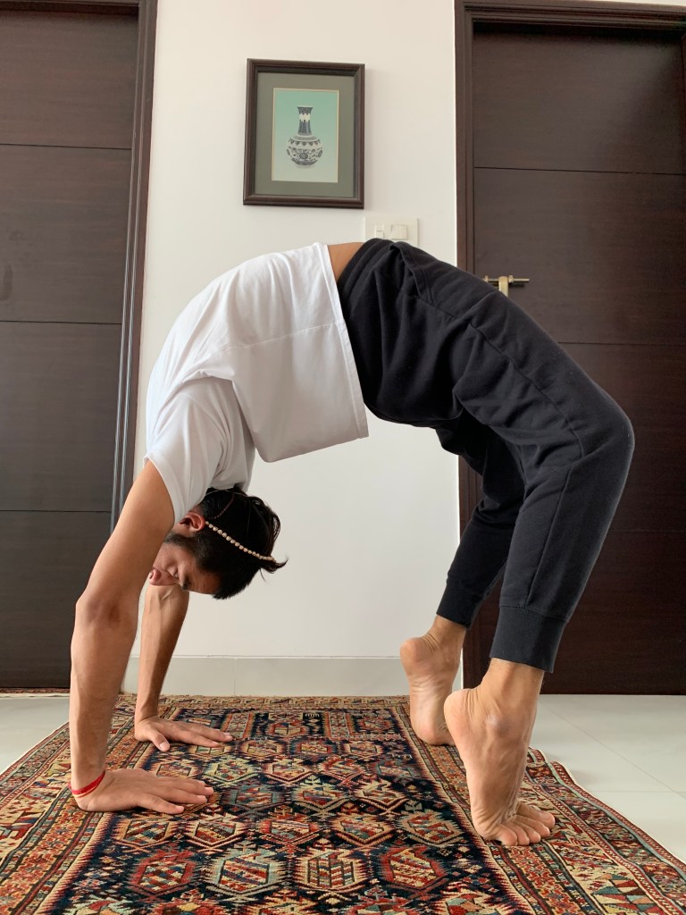 Hatha Yoga Teacher Ayush performing Chakrasana. 