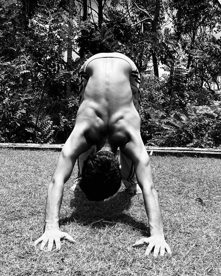 Hatha Yoga teacher Ayush performing Adho Mukha Shvanasana (Downward Dog or Downwardfacingdog Pose) is an inversion posture. 
