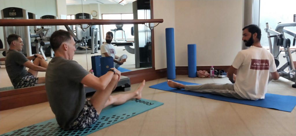 Hathayoga teacher Ayush teaching his yoga clients.