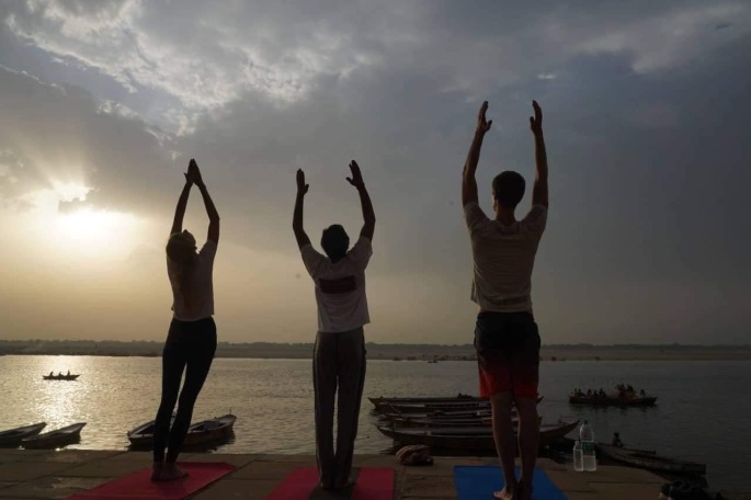 Hatha Yoga Teacher Ayush teaching his classes in Varanasi over looking Ganges with Sunrise. 