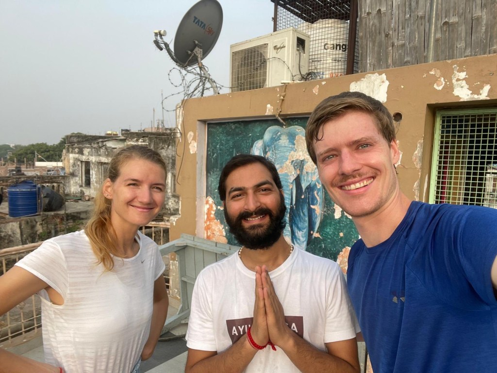 Yoga Teacher Ayush with his students in Namaste position. Guest are happy after Yogaclas and taking picture with smile.