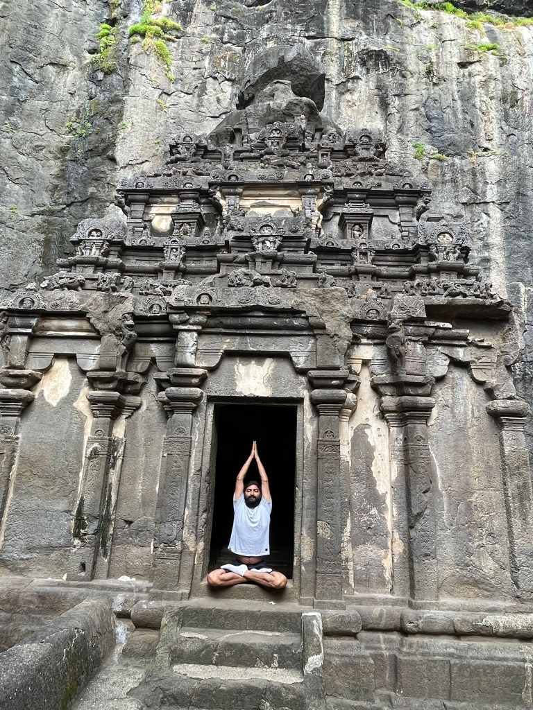 Hatha Yoga Teacher Ayush demonstrating Parvatasana (Mountain Pose) in Padmasana with Namaste Mudra. 