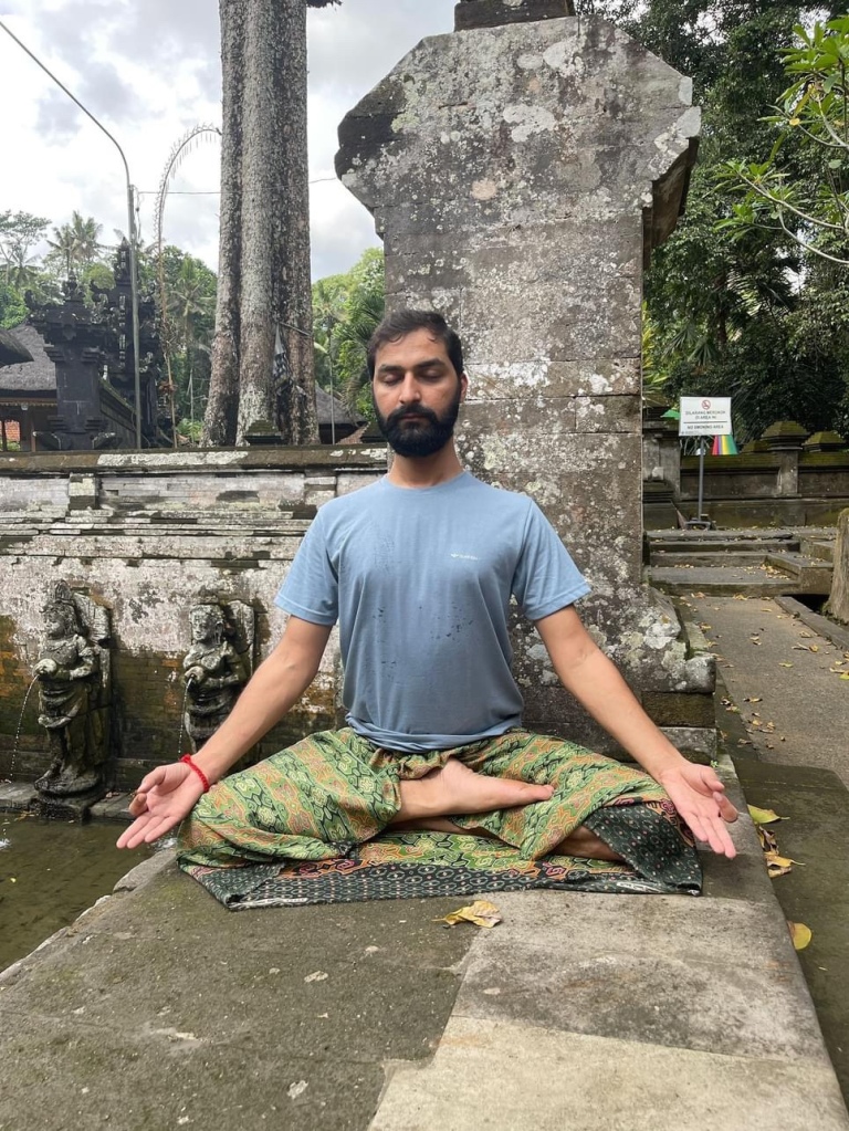Hatha Yoga Teacher Ayush doing Meditation Dhyan in Padmasana with Gyan Mudra. Location Bali Indonesia. 