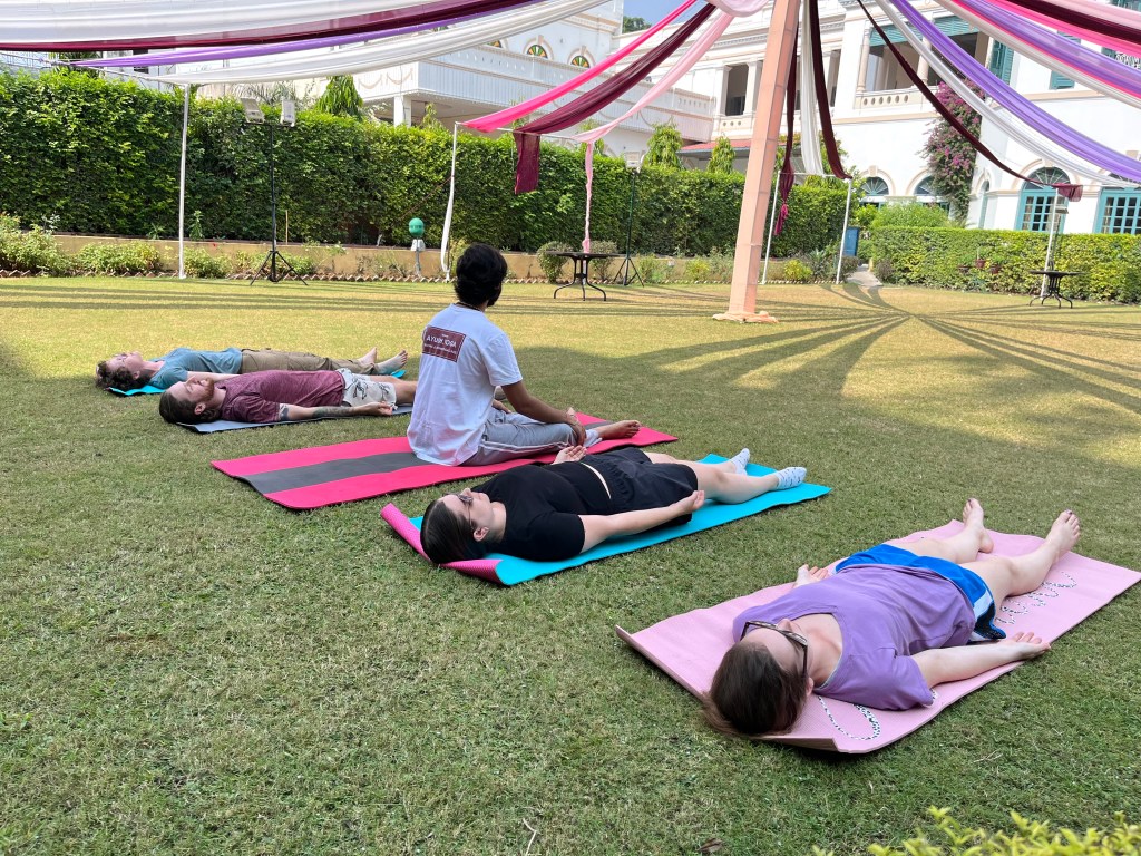 Hatha Yoga Teacher Ayush explaining to the students about Shavasana or Mritasana (Corpse Pose). 