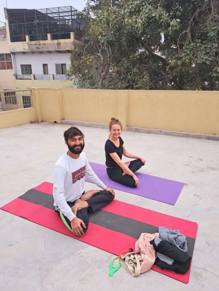 Yoga teacher Ayush with his student. 