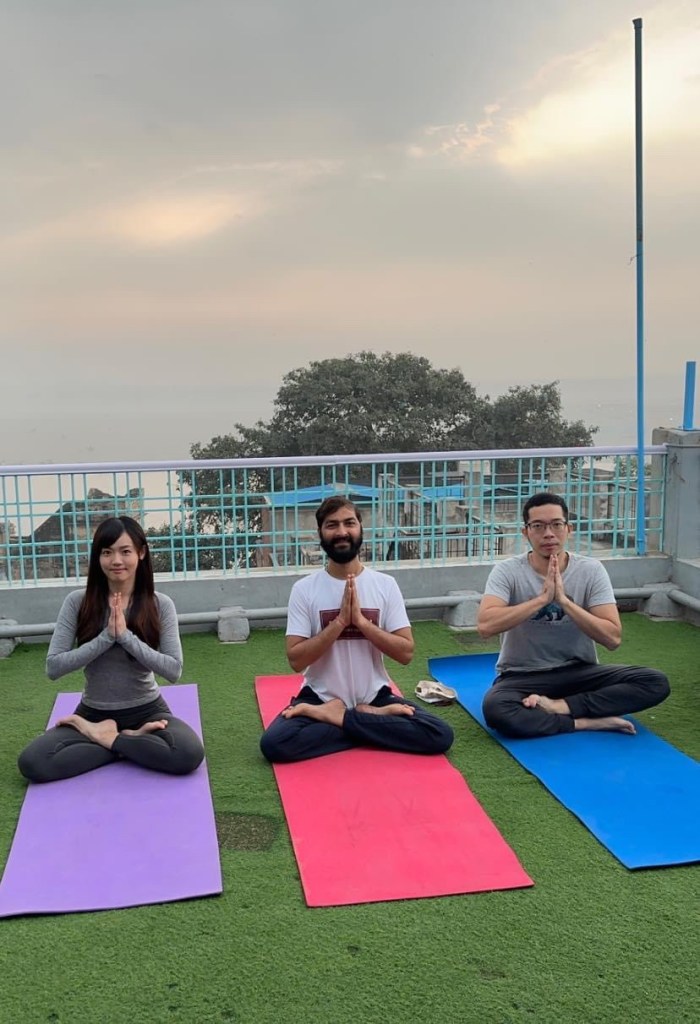 Yoga teacher Ayush with his student in Namaste Mudra.