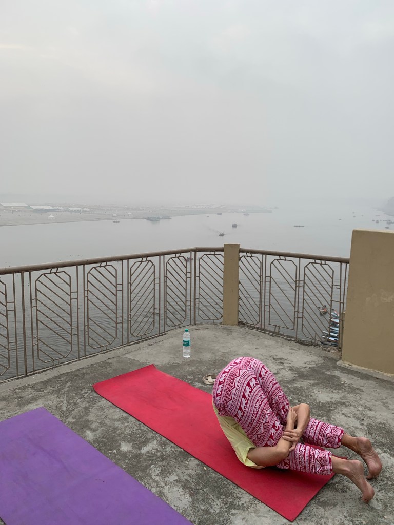 Yoga teacher Ayush student performing Karnapidasana. 