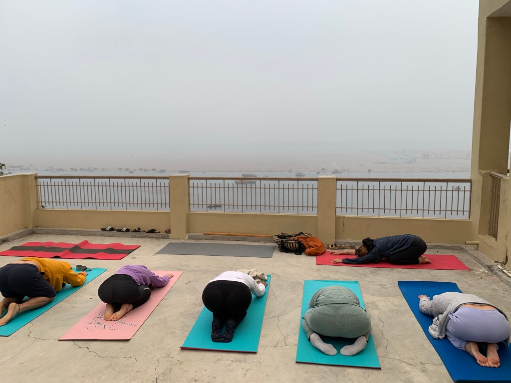 Yoga teacher Ayush students performing Shashankasana. 