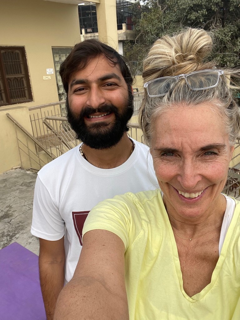 Yoga teacher Ayush with his student.
