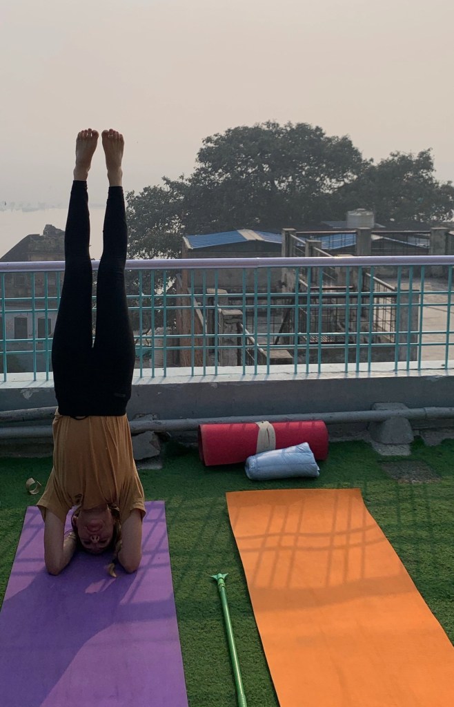 Yoga teacher Ayush student performing Sirshasana. 