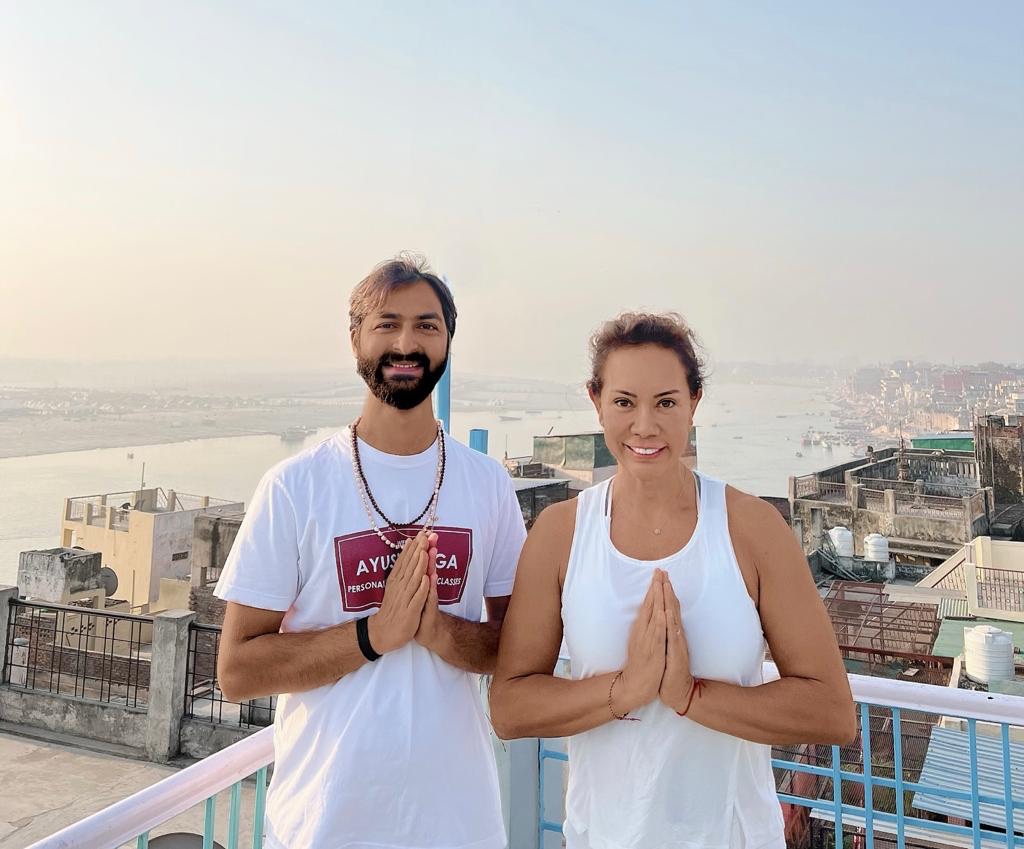 Yoga teacher Ayush with his student in Namaste Mudra. 