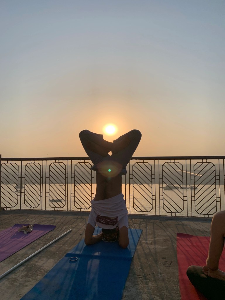 Yoga teacher Ayush demonstrating Sirshasana Variation. 