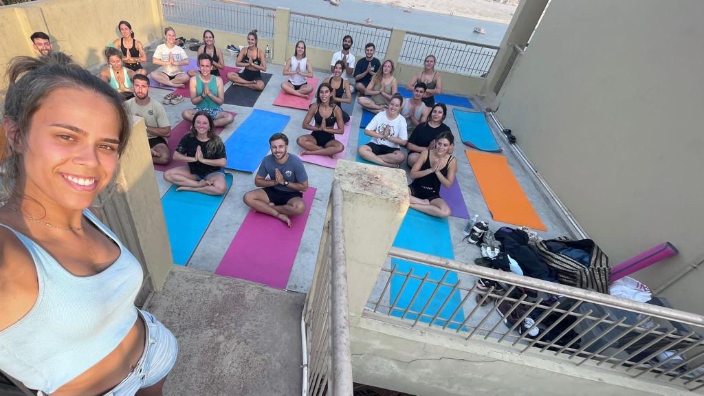 Yoga teacher Ayush with his students in Namaste Mudra. 