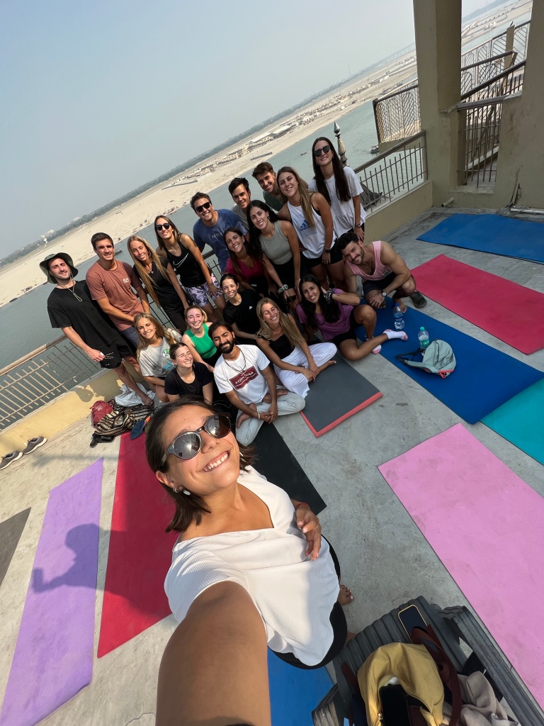 Girl taking selfie after the yoga session with teacher and her group.