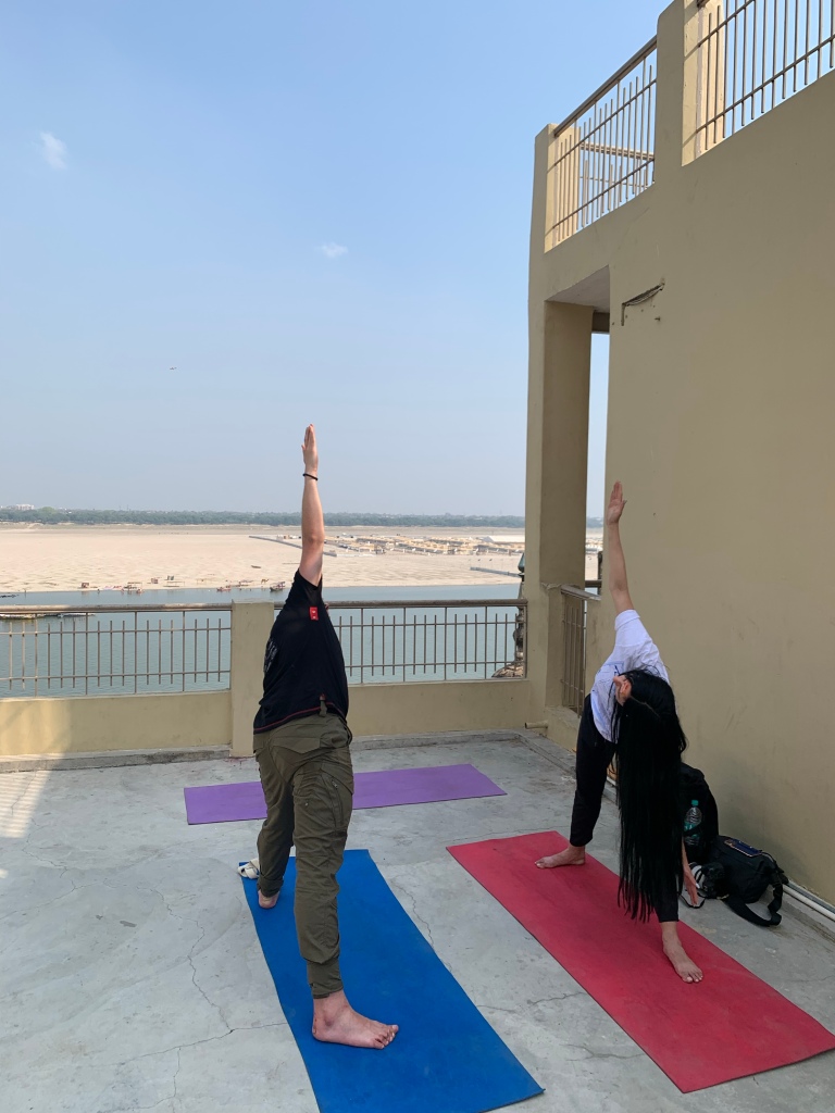 Yoga teacher Ayush students performing Triangle Pose. 
