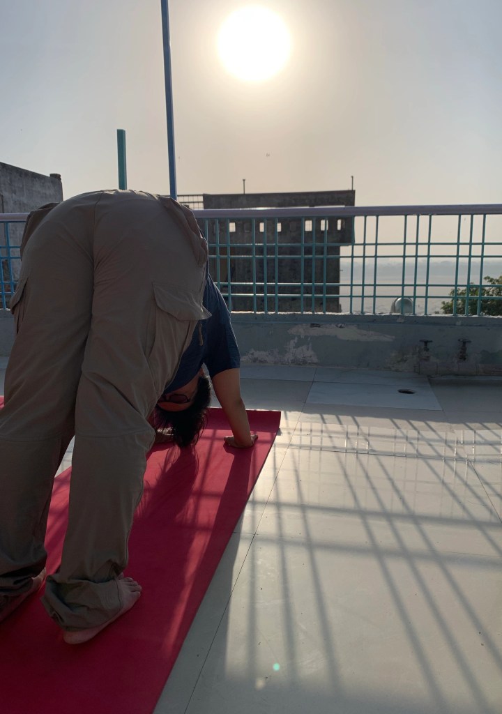 Yoga teacher Ayush student performing Downward Facing Dog in Varanasi. 