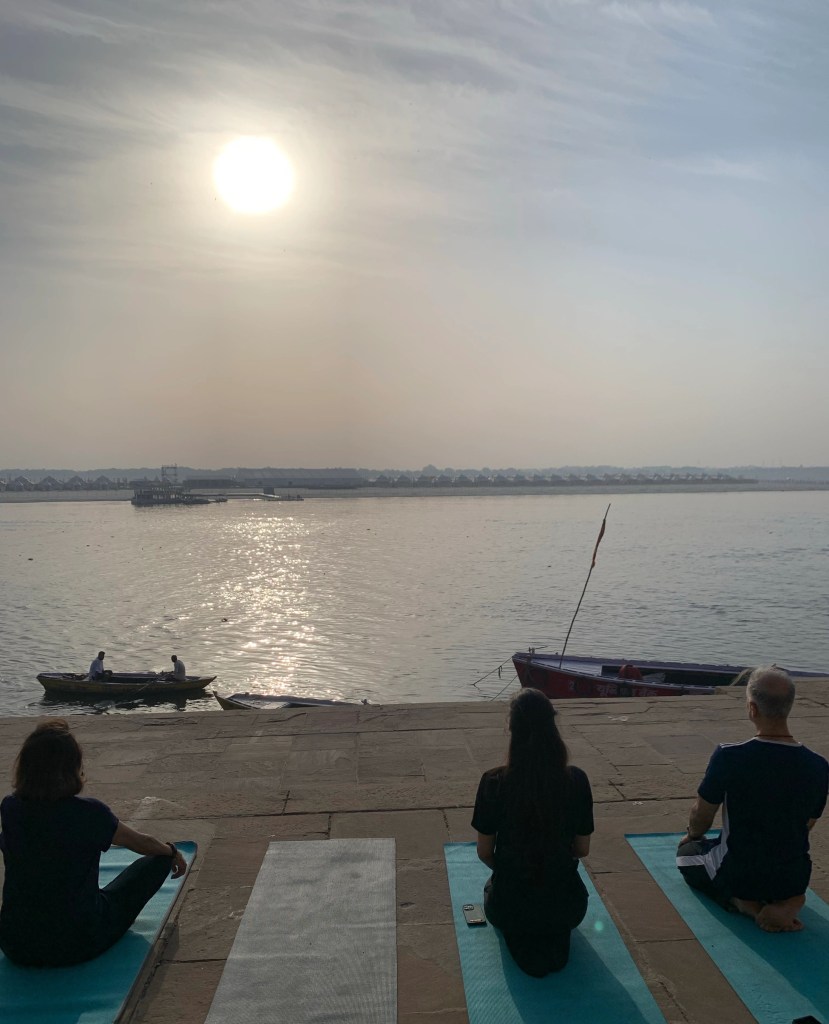 Yoga teacher Ayush students doing meditation in Varanasi over looking Ganga. 