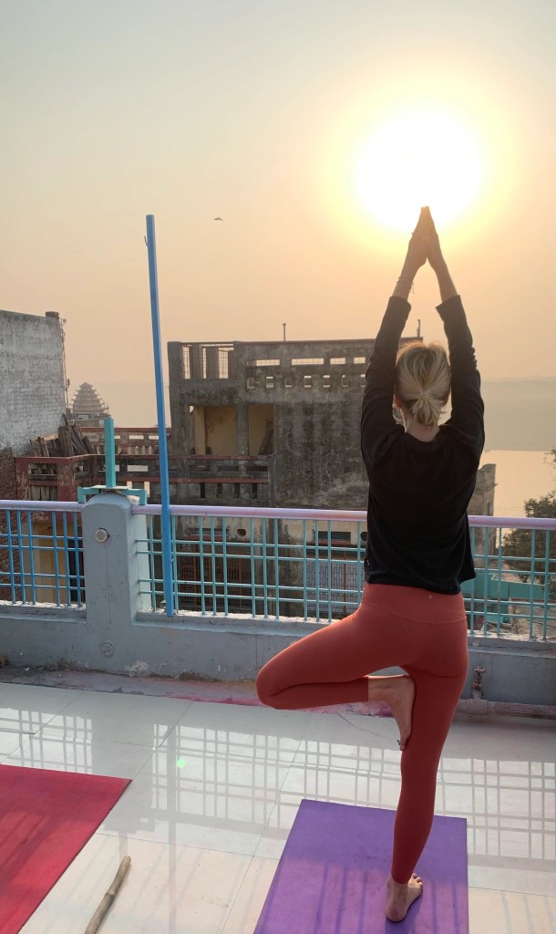 Yoga teacher Ayush students performing Vriskhasana overlooking Sunrise. 
