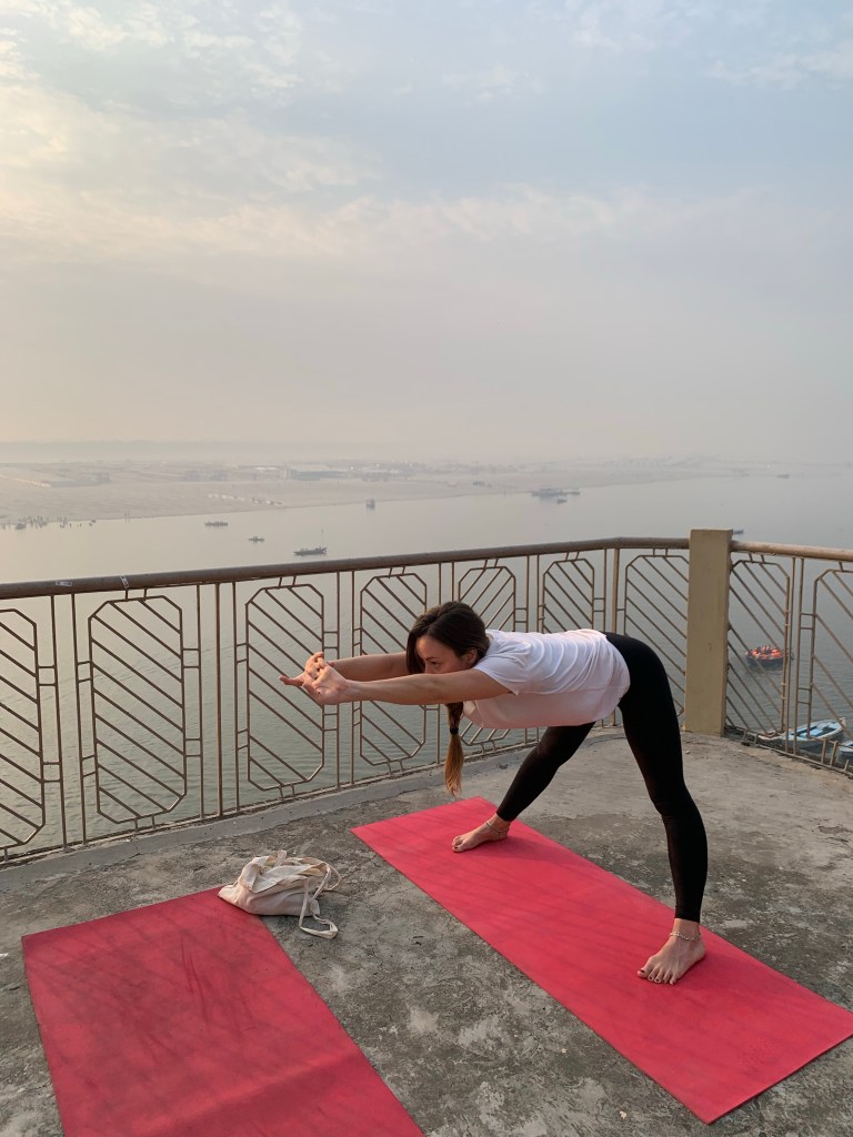 Yoga teacher Ayush student performing Wide Legged Standing Forward Bend Pose in Varanasi. 