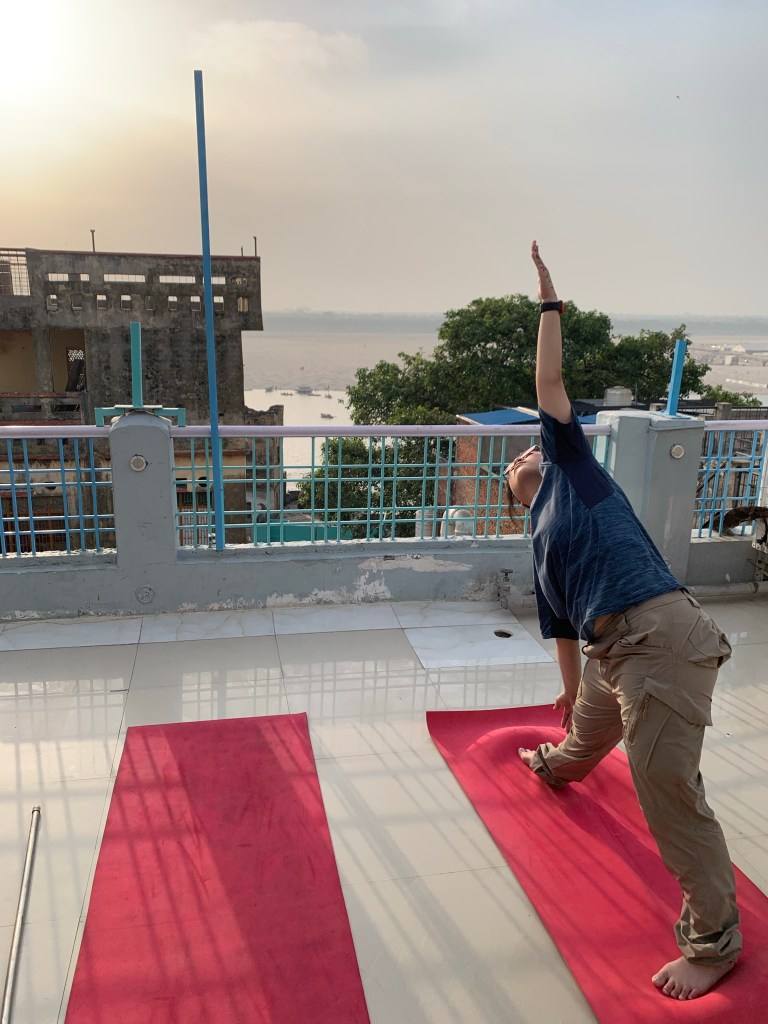Yoga teacher Ayush student performing Triangle Pose in Varanasi. 