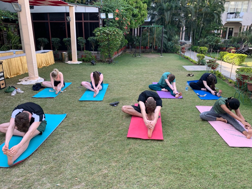 Yoga teacher Ayush students performing Janusirsasana in Varanasi. 