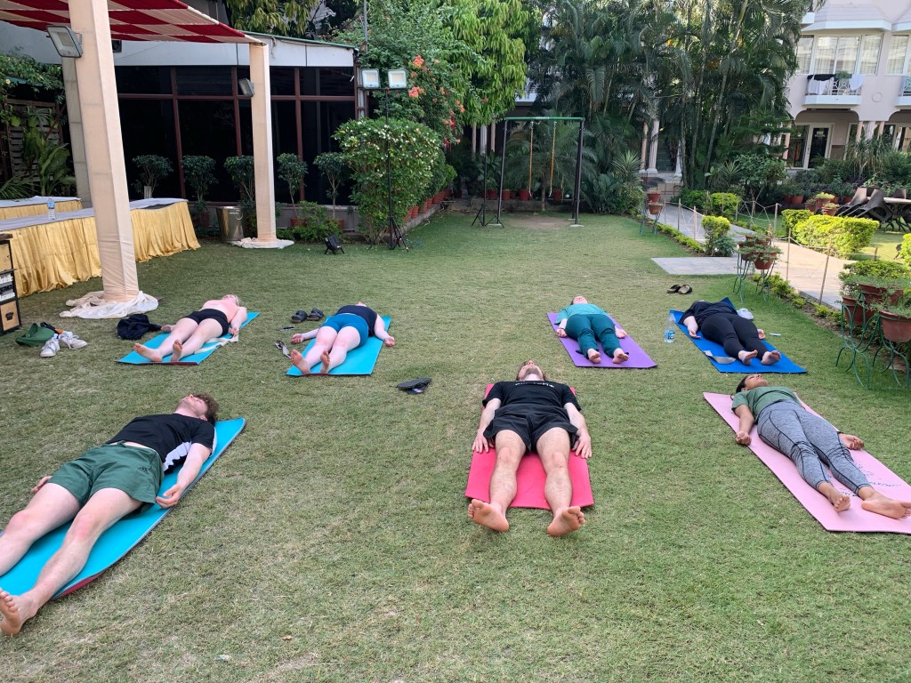 Yoga teacher Ayush students performing Shavasana in Varanasi. 